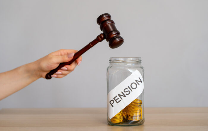 Bank of coins Pension and gavel. Legal disputes or claims involving pension benefits for Teachers